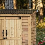 Wooden shed with black metal roof