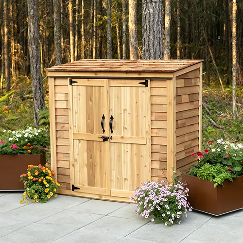 Wooden shed surrounded by colorful flowers