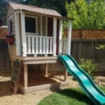 Colorful playhouse with green slide.