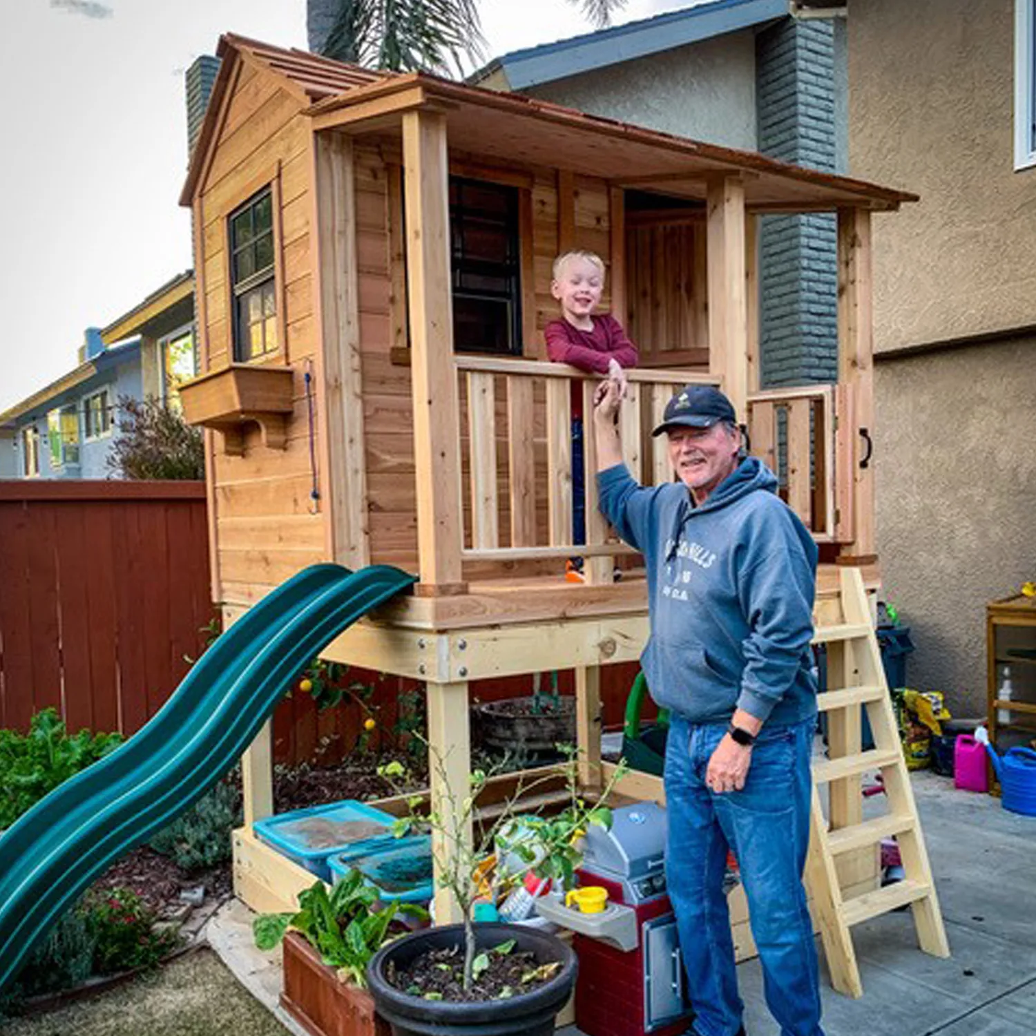 Child playing in wooden playhouse.