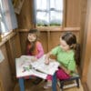 Children coloring in a playhouse.