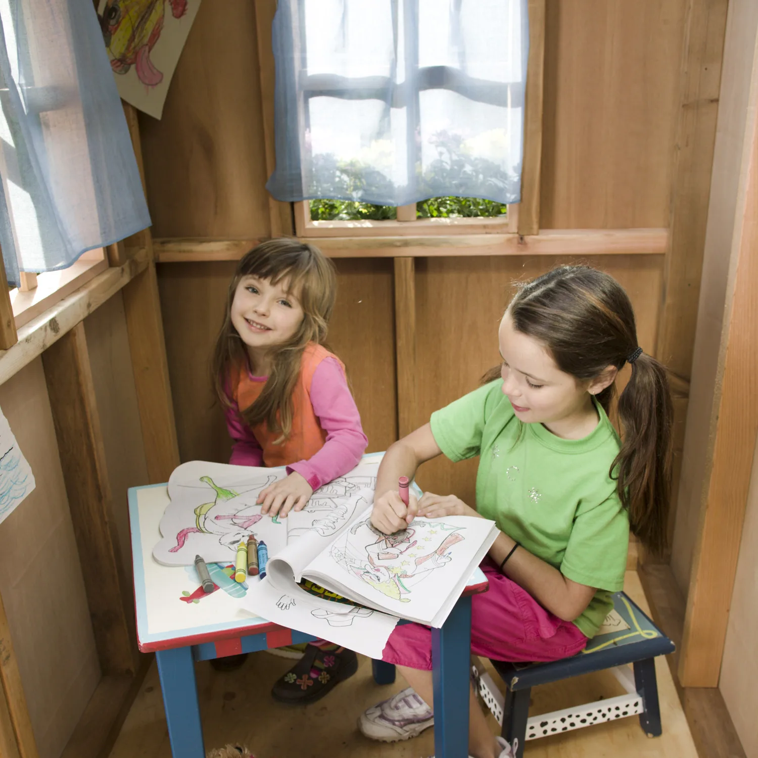 Children coloring in a playhouse.
