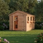 Wooden shed surrounded by lush greenery
