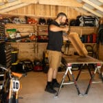 Man working in a wooden shed.