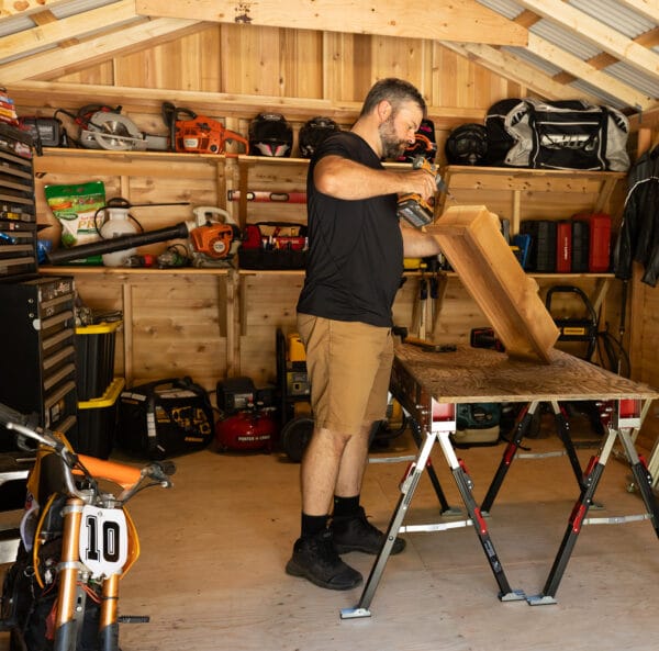 Man working in a wooden shed.