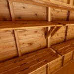 Wooden shelves on a cedar ceiling.