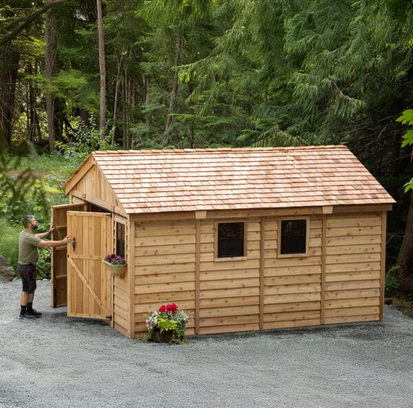 Wooden shed in a forested area.