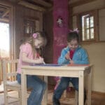 Two children playing in playhouse.