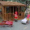 Children playing in a wooden playhouse.