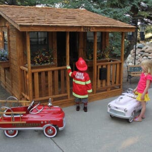 Children playing in a wooden playhouse.