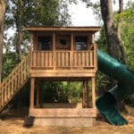 Wooden playhouse with slide and stairs