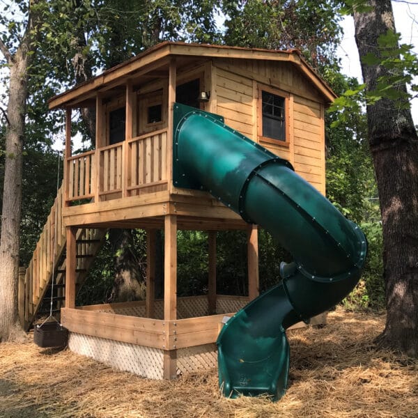 Wooden playhouse with green slide