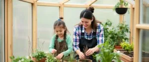 OLT Mother and daughter gardening in a cedar greenhous b272f406 c5e9 464b a37e 1d9b8971775a