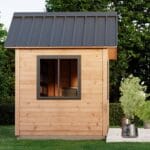 Wooden shed with metal roof, window.
