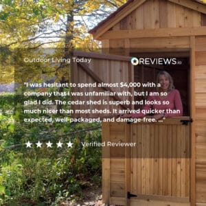 Wooden shed surrounded by trees.