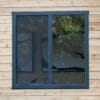 Black framed window on wooden wall