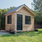 Modern wooden shed with black roof