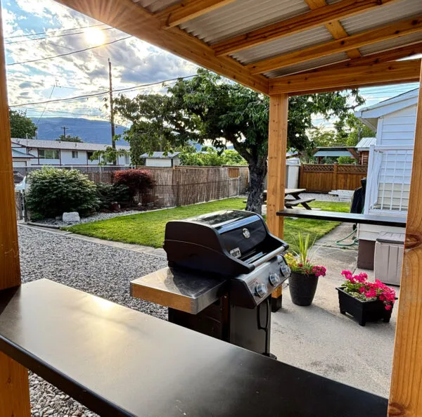 Outdoor grill under wooden gazebo