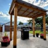 Outdoor grill under wooden gazebo
