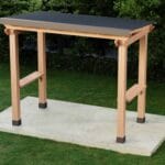 Wooden outdoor shelter with black roof