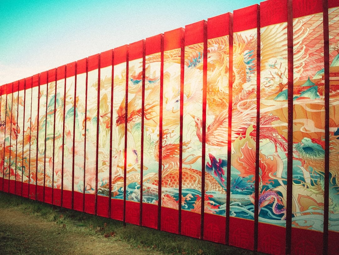 Long mural with colorful mythical creatures and red borders