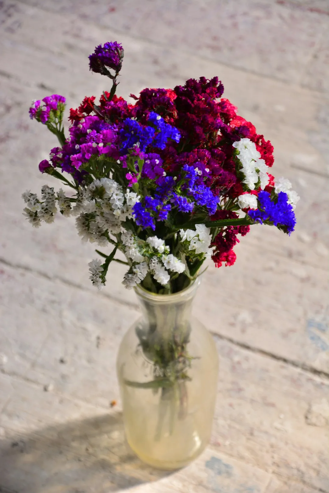 Photo by Volodymyr Tokar purple flowers in clear glass vase