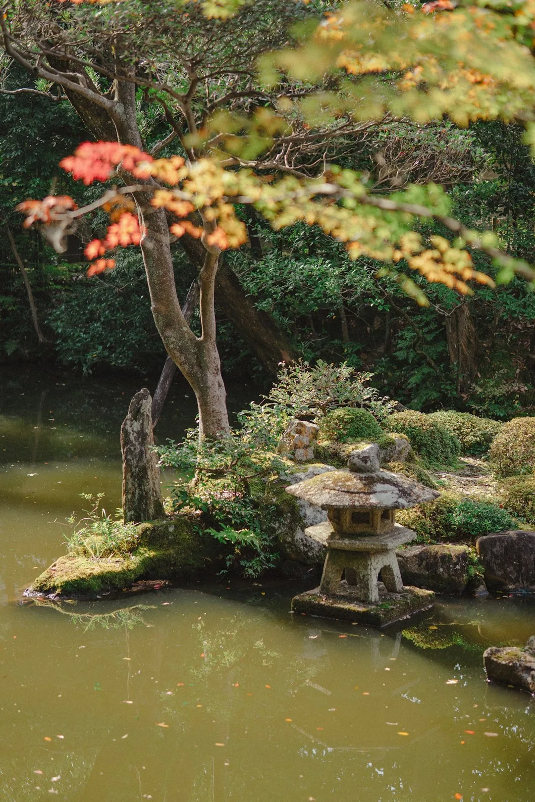 Stone lantern in a tranquil japanese garden pond