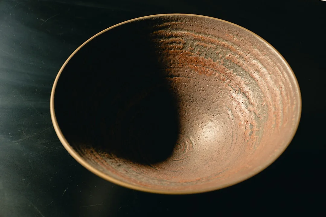 Photo by Jason Leung A brown bowl sitting on top of a table
