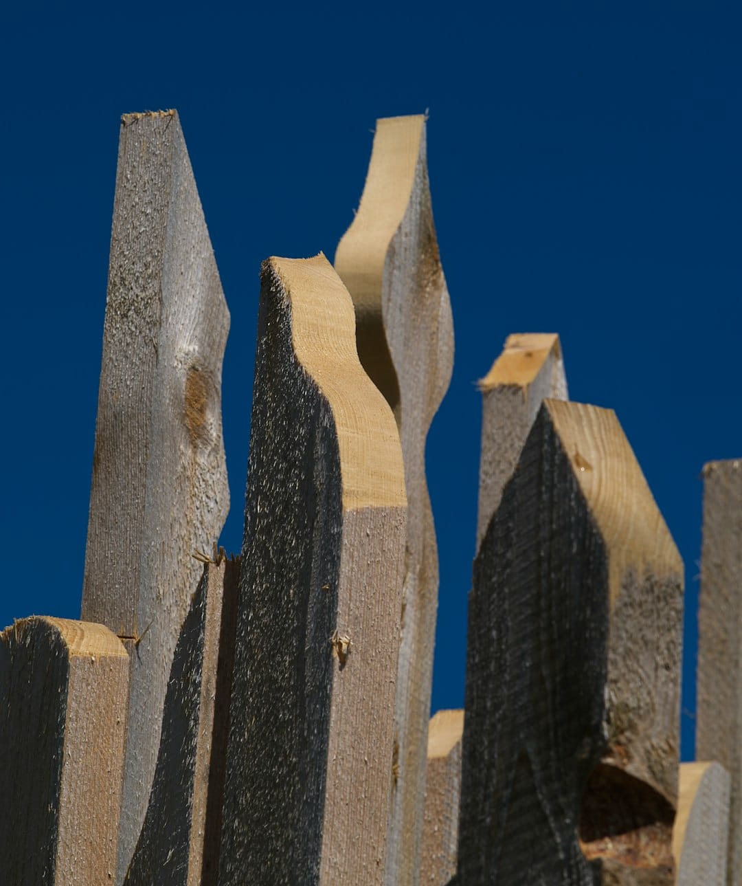 a close up of a wooden fence against a blue sky