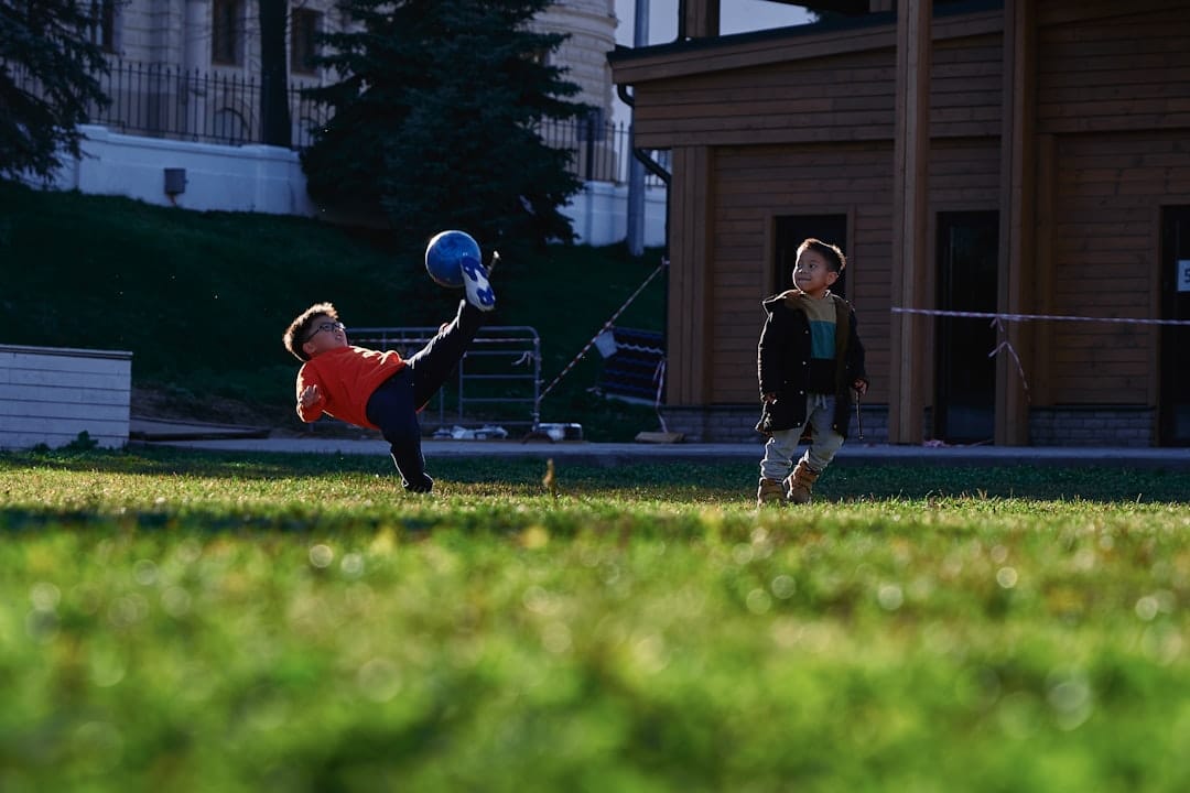 a small child swinging a bat at a ball