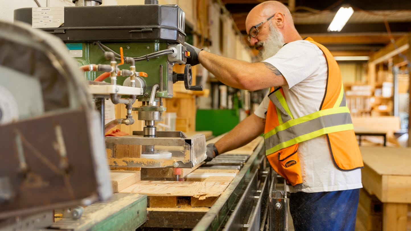 Premium Cedar Structures for Commercial Projects, Volume Orders & Retail Programs Outdoor Living Today 7 Man operating woodworking machinery in workshop